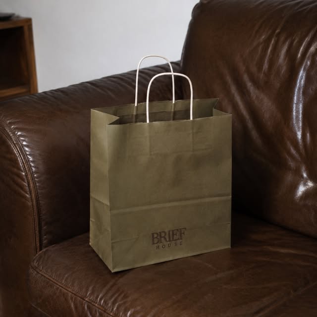 Custom printed shopping bags on a leather chair