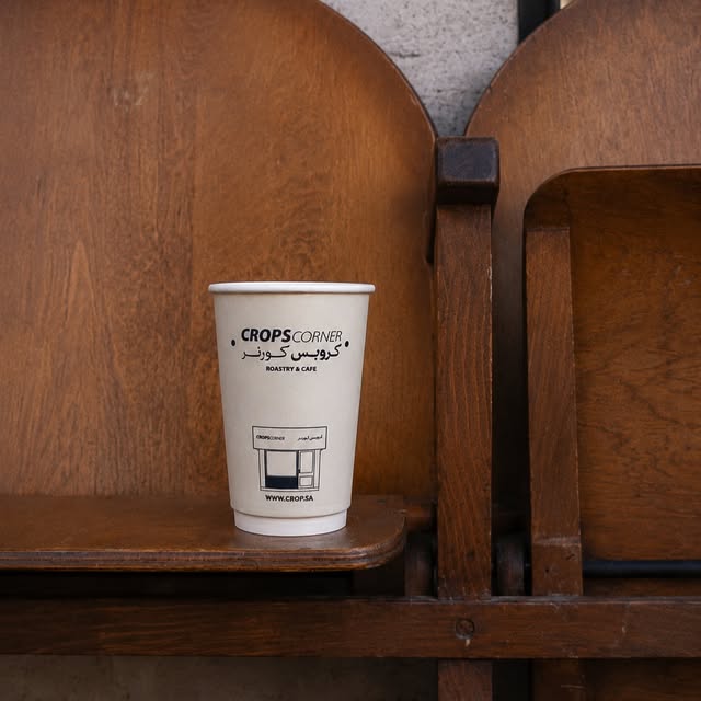 A custom printed coffee cup on a wooden chair